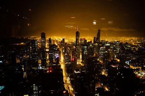 Free Stunning aerial night view of a cityscape with illuminated skyscrapers and streets. Stock Photo