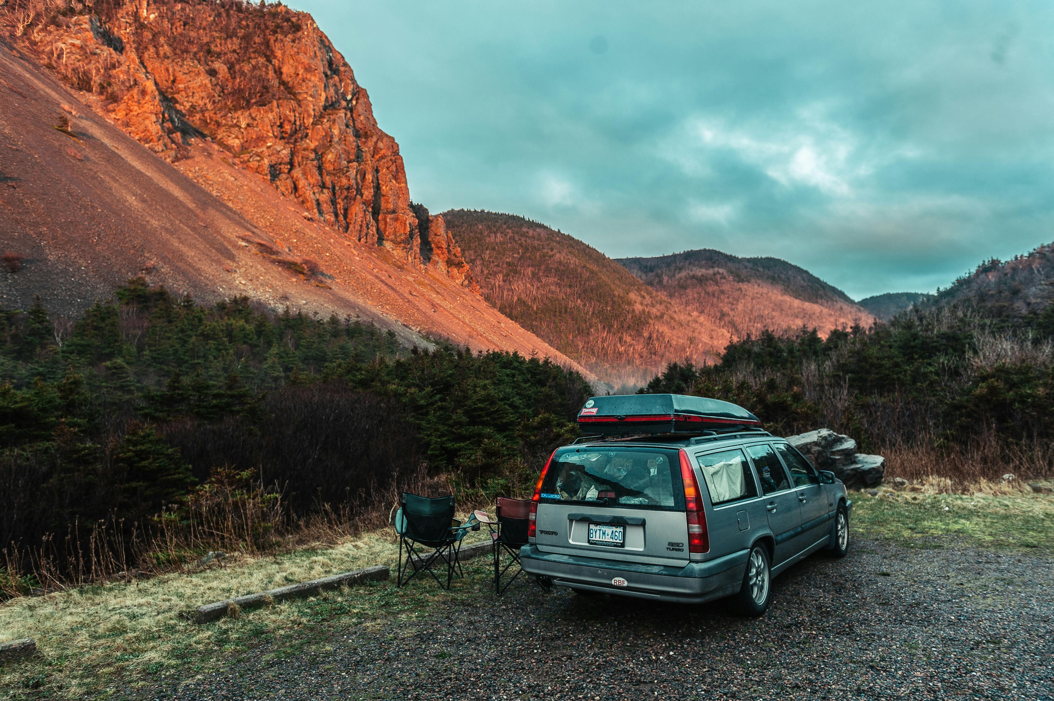 Free Gray Suv Near Field Viewing Mountain Stock Photo