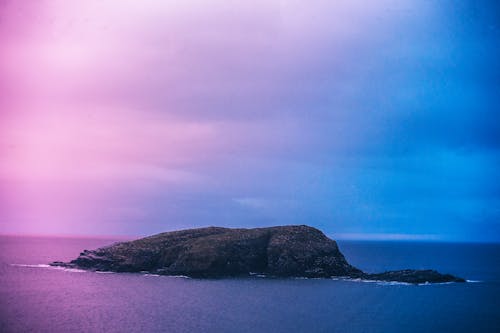 Green Island Under Blue and Pink Skies