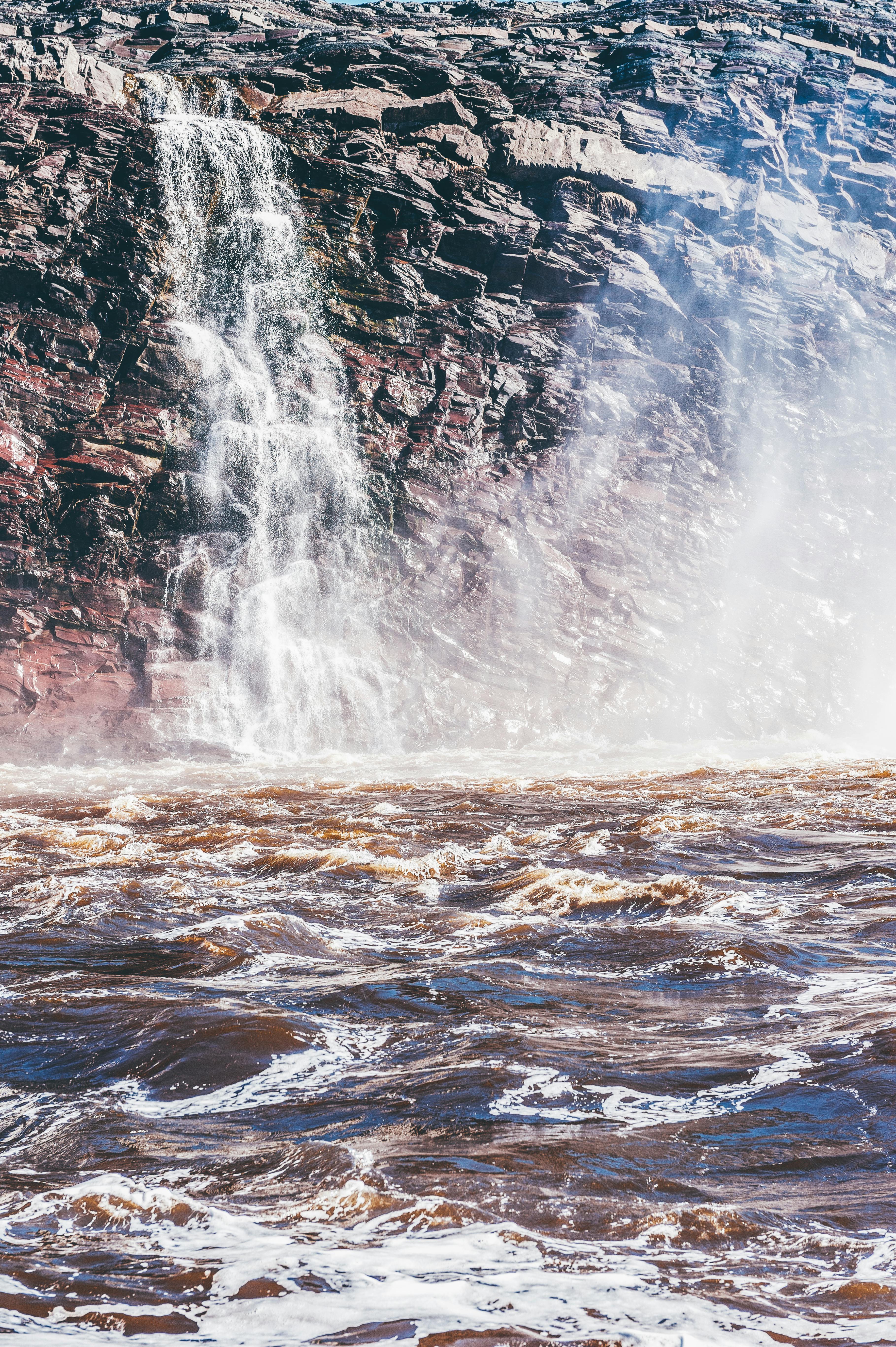 水流从崎岖的岩石上倾泻而下，形成戏剧性的瀑布，水花飞溅