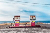 White and Pink Gasoline Station Near Ocean