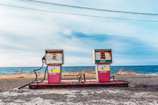 White and Pink Gasoline Station Near Ocean