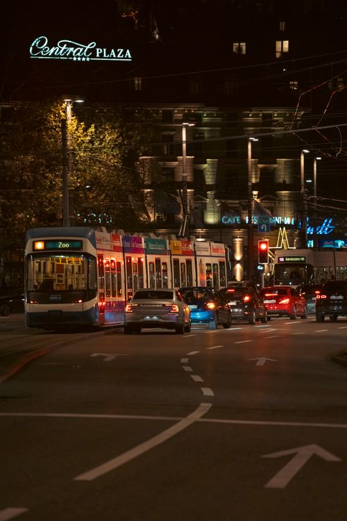 Free Street view at night with a brightly lit tram and city lights. Stock Photo