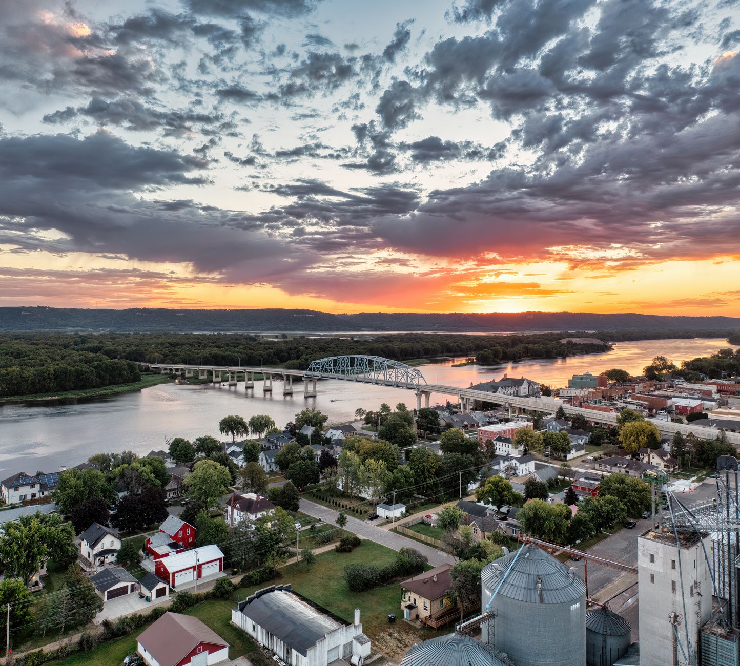 A breathtaking aerial view of Wabasha, MN, showcasing the Mississippi River and a striking sunset.