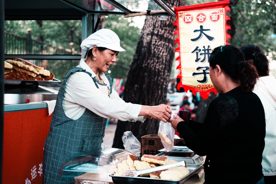 A close-up of a freshly made Jianbing or Roujiamo, popular Chinese street food