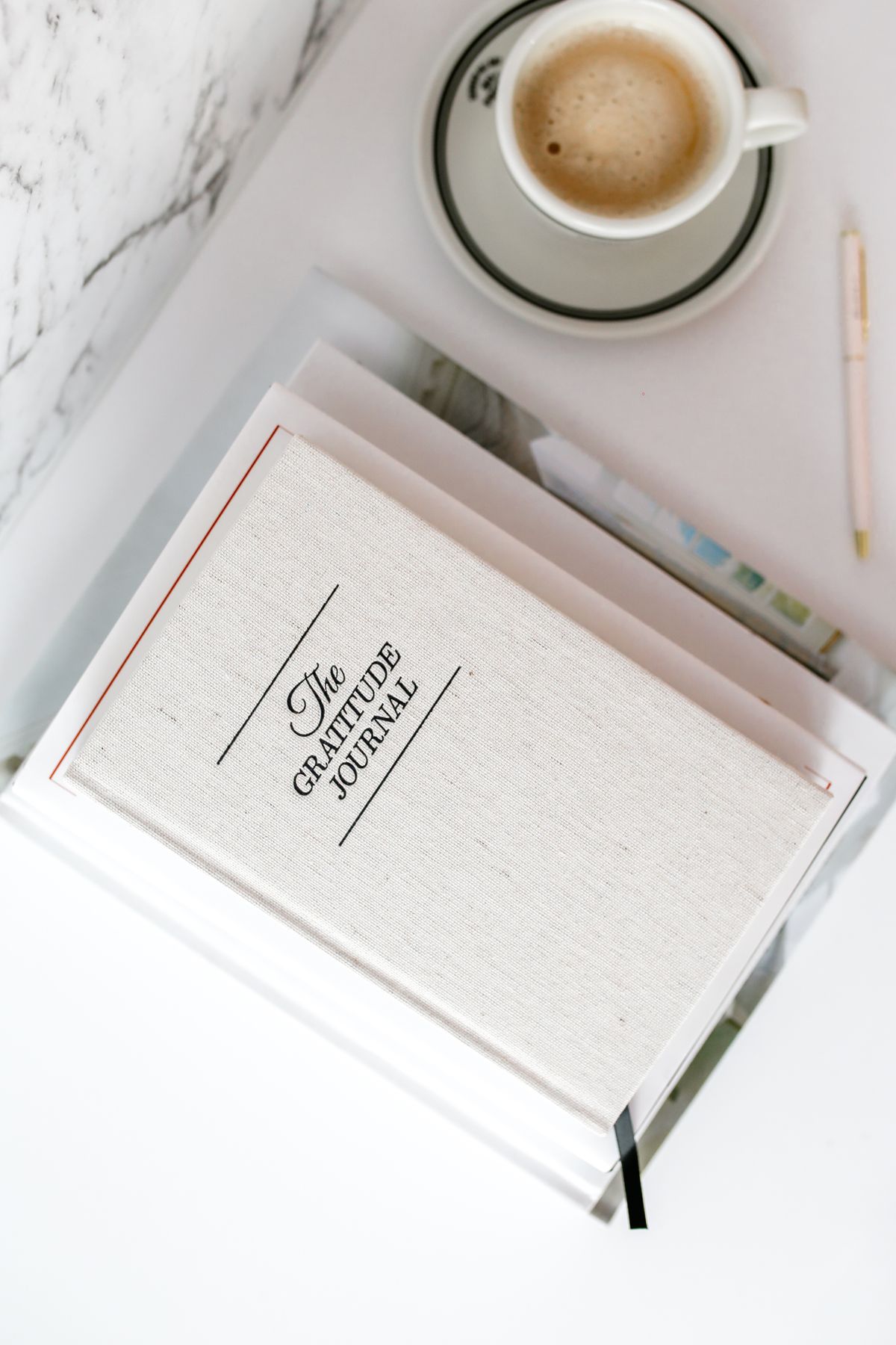 Closed gratitude journal resting on a clean desk surface