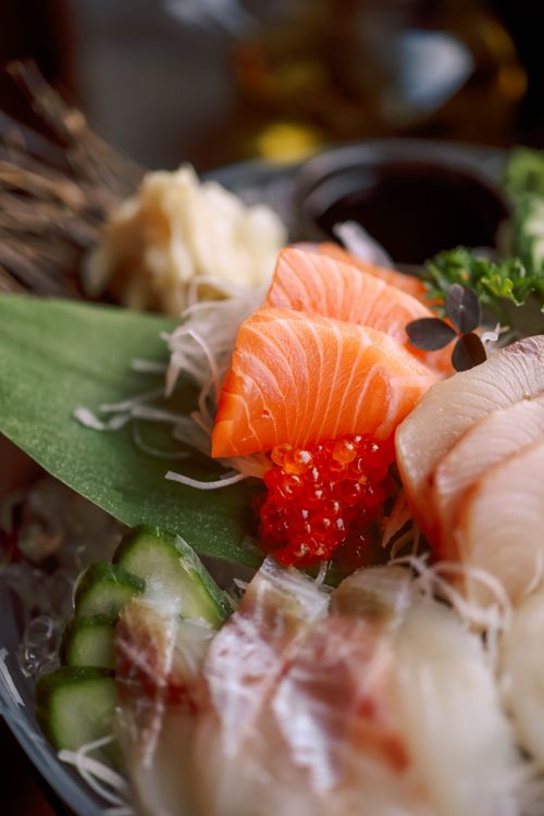Free A vibrant dish showcasing fresh sashimi with salmon, cucumbers, and garnish. Stock Photo
