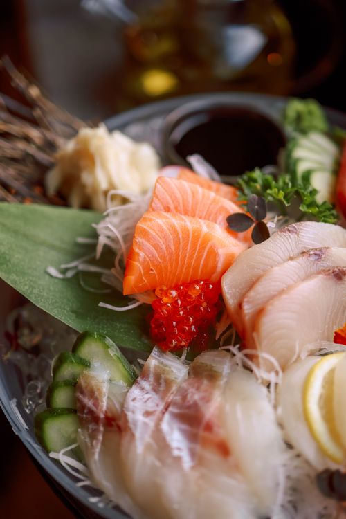 Free A close-up of a beautifully arranged sushi platter showcasing fresh sashimi and garnishes. Stock Photo