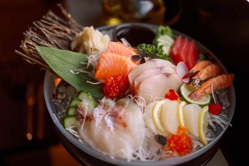 Free Colorful sushi platter featuring fresh sashimi, shrimp, and garnishes, artfully arranged. Stock Photo