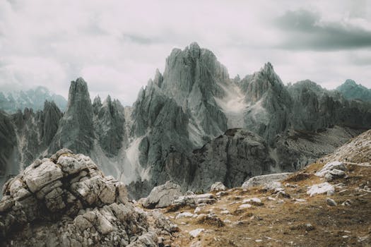 Breathtaking view of the rugged Dolomites during daylight with dramatic clouds.