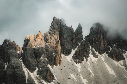 Free Majestic Dolomite peaks in cloudy weather, showcasing rugged beauty and natural grandeur. Stock Photo
