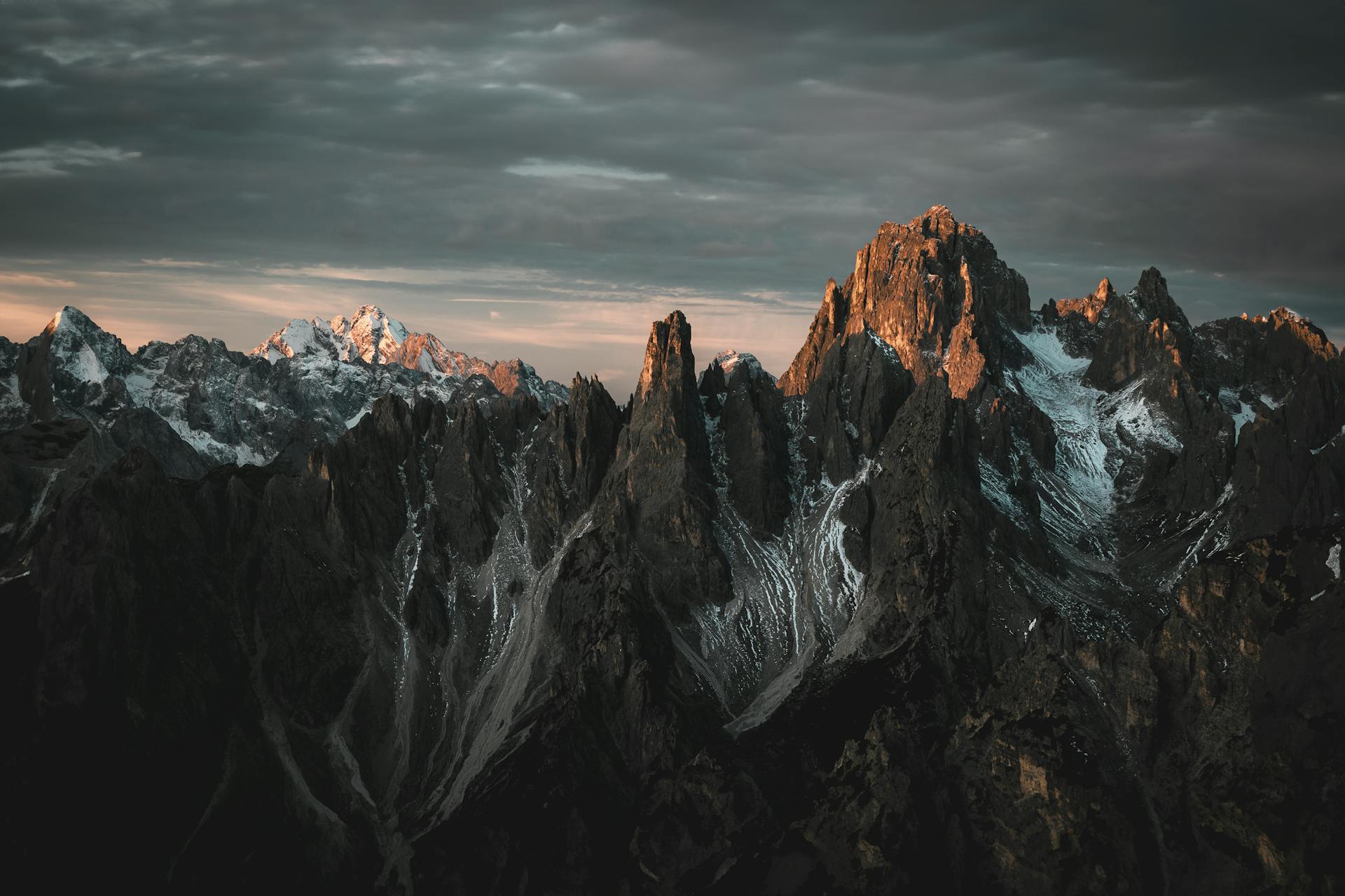 Dramatic mountain peaks at twilight, showcasing rugged landscapes and stunning scenery.