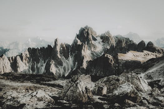 Breathtaking view of rugged mountain peaks surrounded by rocks and snow.