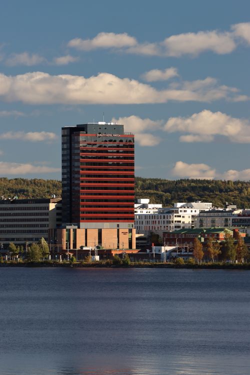 Free Scenic view of Jönköping, Sweden featuring a prominent skyscraper and lake under a cloudy sky. Stock Photo