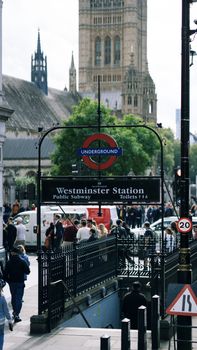 Crowds gather at Westminster Underground Station with iconic Big Ben in the backdrop.