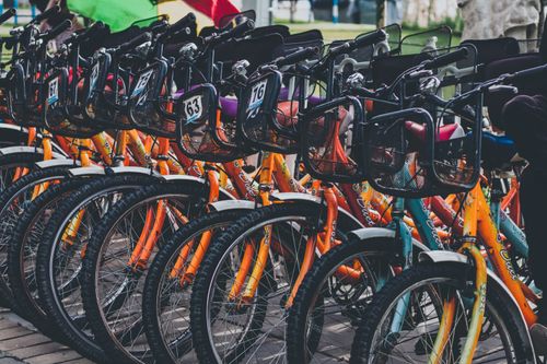 Free Vibrant and colorful bicycles neatly lined up outside, perfect for rental or urban transportation. Stock Photo