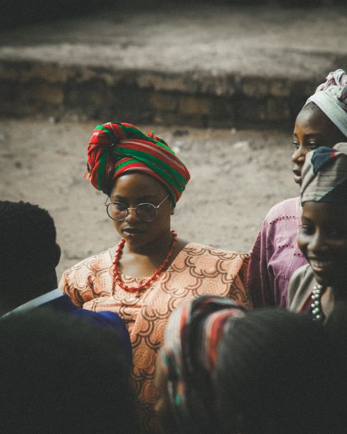 Free A group of African women in vibrant traditional clothing are gathered outdoors, showcasing cultural heritage. Stock Photo