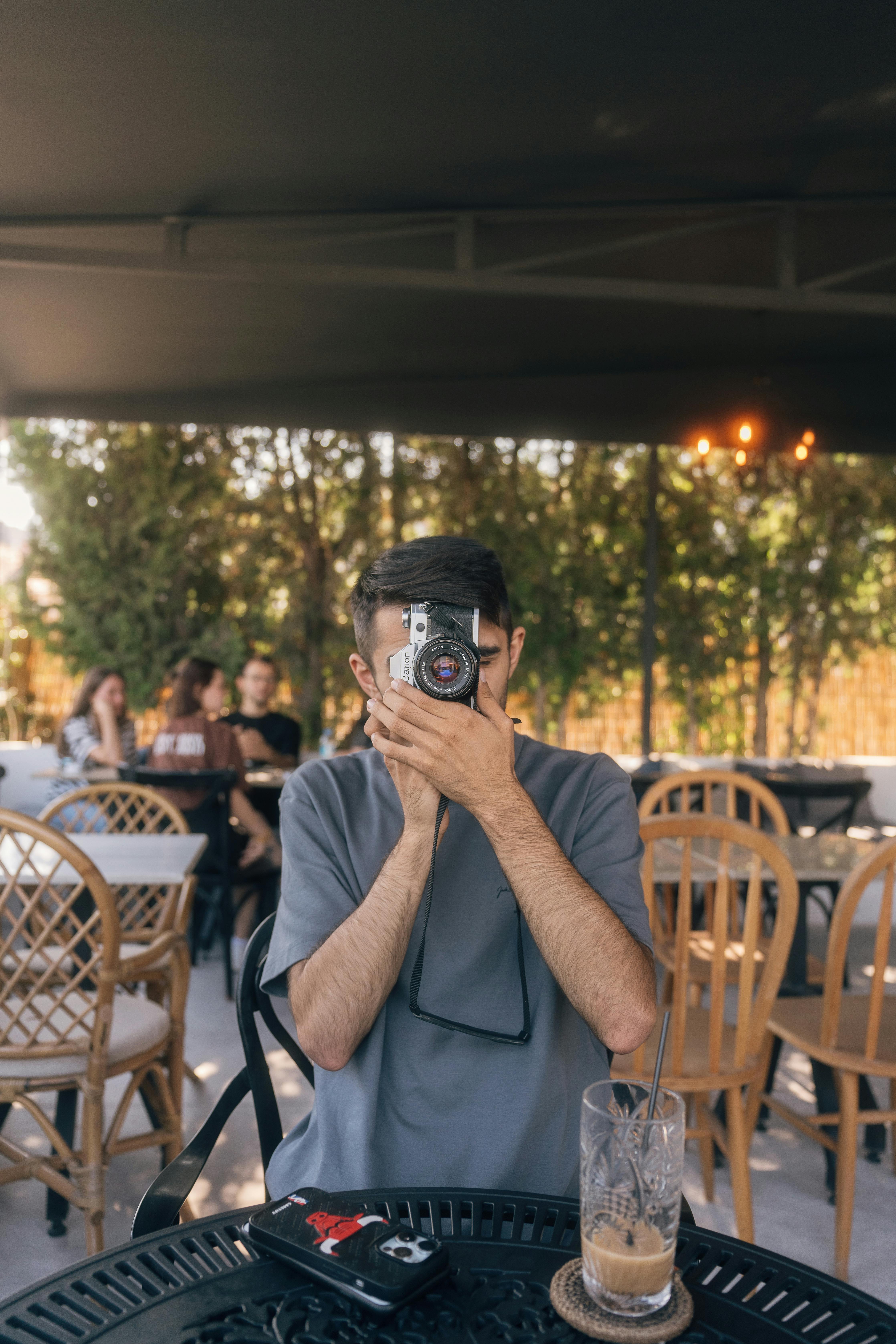 photographer capturing moment at outdoor cafe