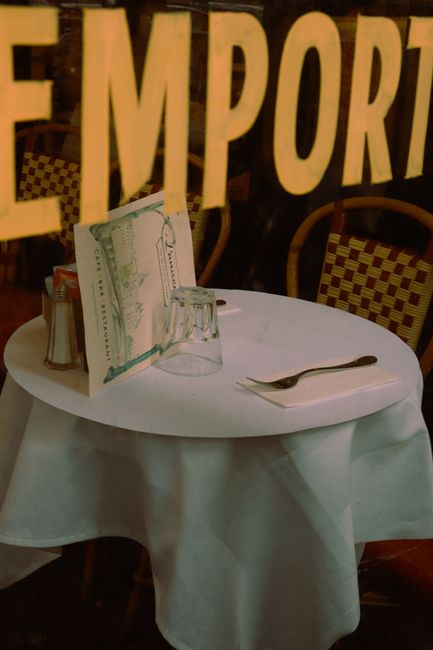 Charming Paris cafe table setup with vintage decor reflecting typical bistro ambiance in a cozy setting.
