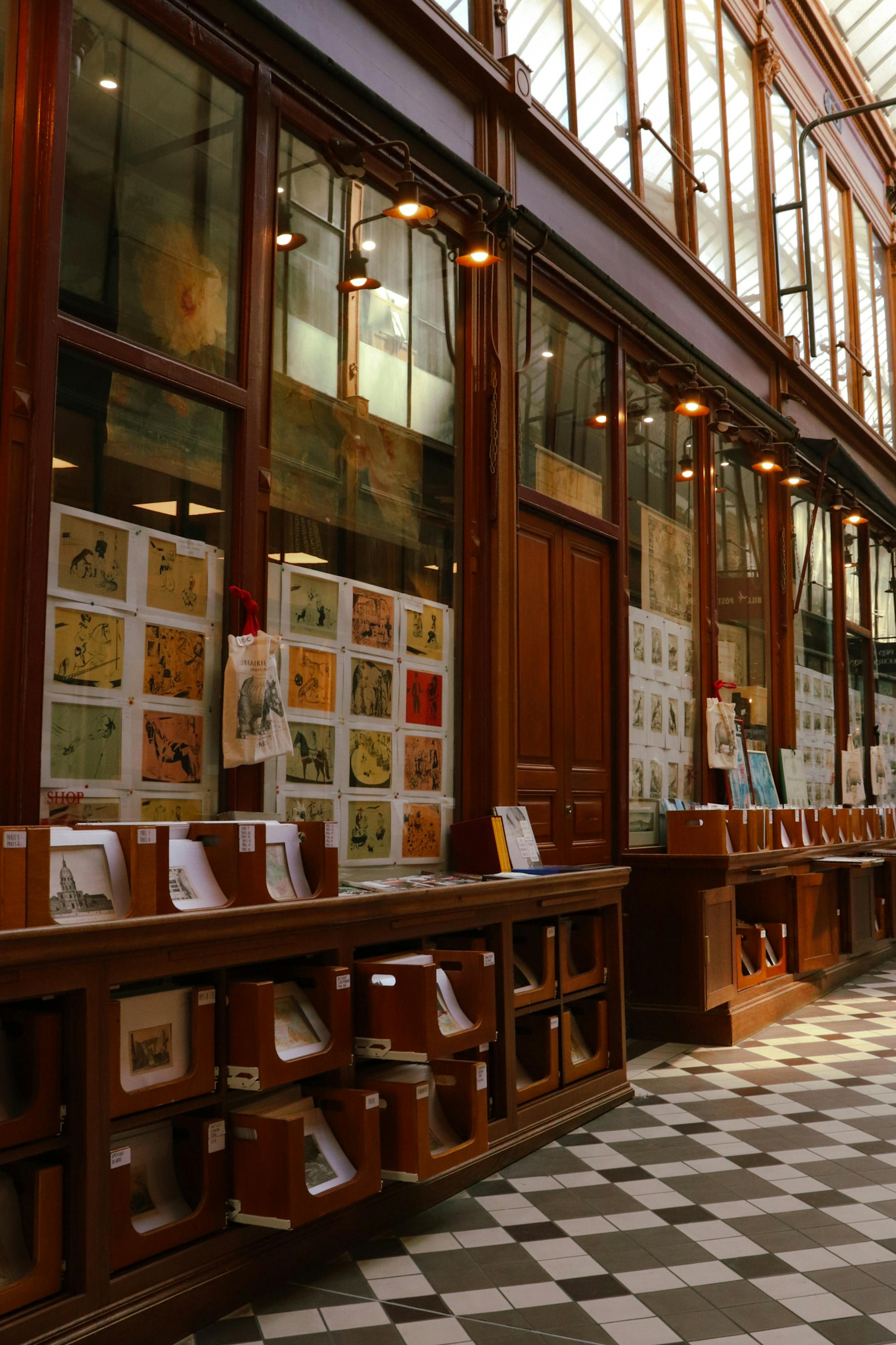 Explore a quaint bookstore filled with vintage prints in a historic Paris passageway.