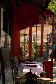 A quaint Parisian cafe with outdoor seating, reflecting the charming street life of Paris.