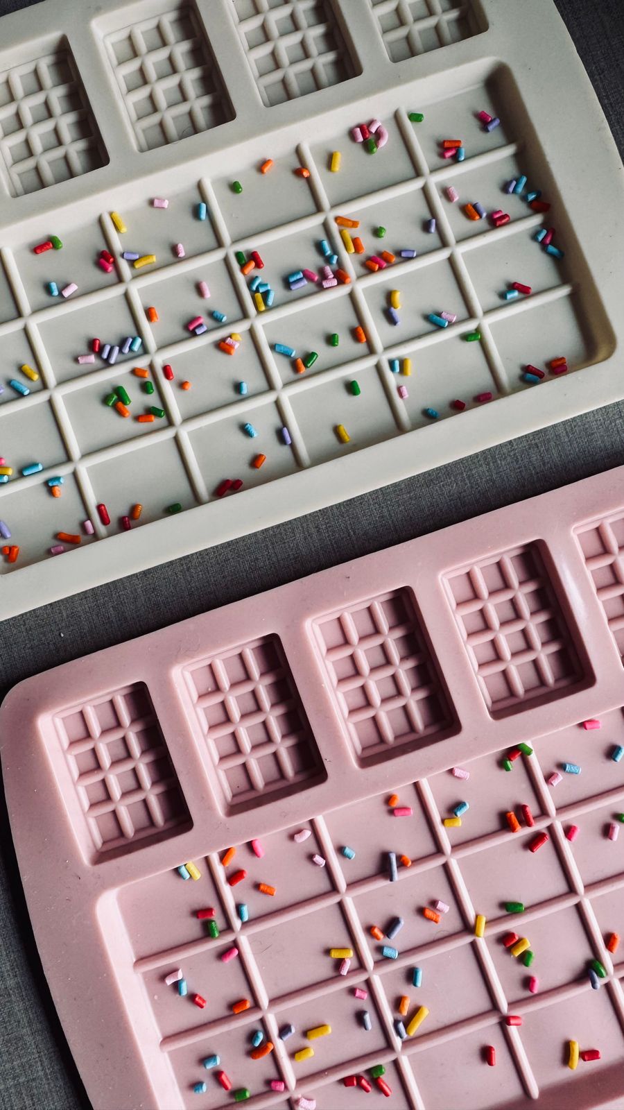 Silicone moulds scattered with sprinkles