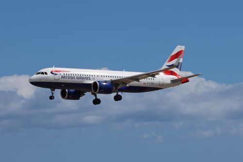 Free A British Airways Airbus A320 airliner flying against a clear blue sky. Stock Photo