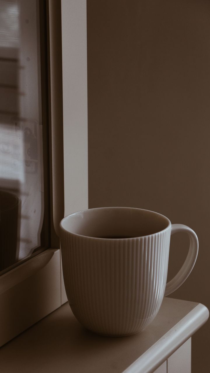 small window sill coffee nook in a corner with a pour over setup and potted plant