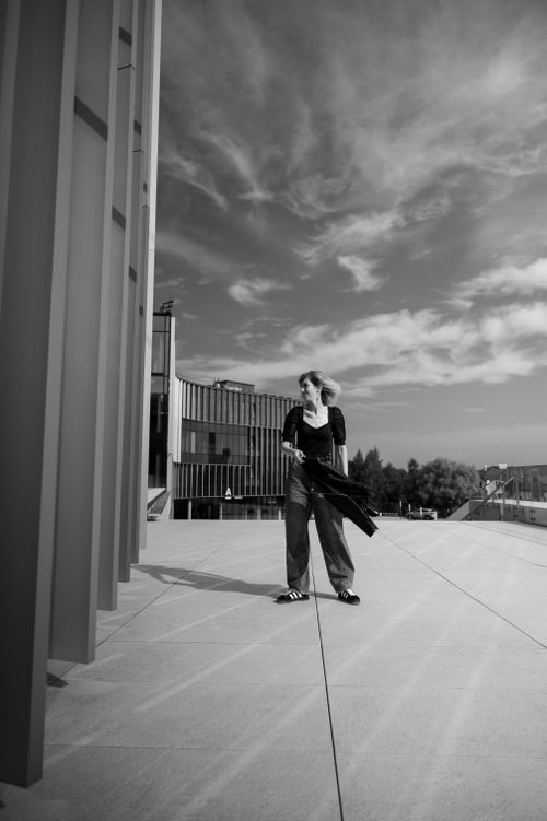 Free Stylish woman in urban setting, monochrome with modern architecture. Stock Photo