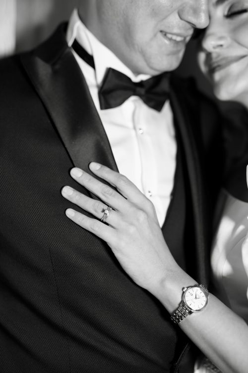 Free Close-up black and white photo of a couple in formal attire, highlighting the watch and rings. Stock Photo