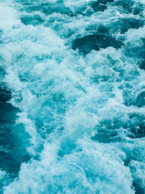 Vibrant ocean waves captured in motion, showcasing foam and energy.