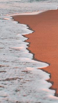 Peaceful seascape during golden hour in Tabarka, Tunisia, showcasing a sandy shoreline and gentle waves.