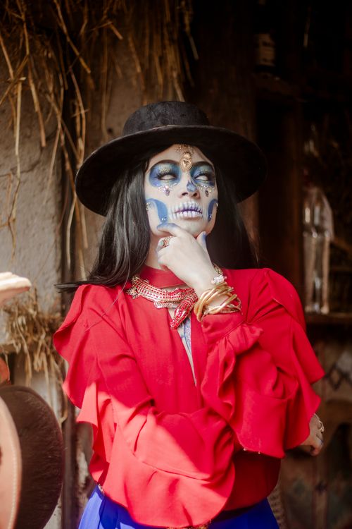 Free Woman in Day of the Dead makeup and outfit posing outdoors. Stock Photo