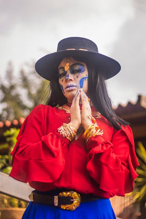 Free Vibrant portrait of a woman with sugar skull makeup celebrating Day of the Dead. Stock Photo