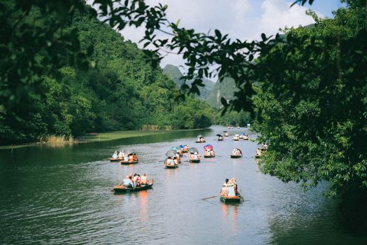 Peaceful boat tour through lush landscapes and rivers in Ninh Bình, Vietnam.