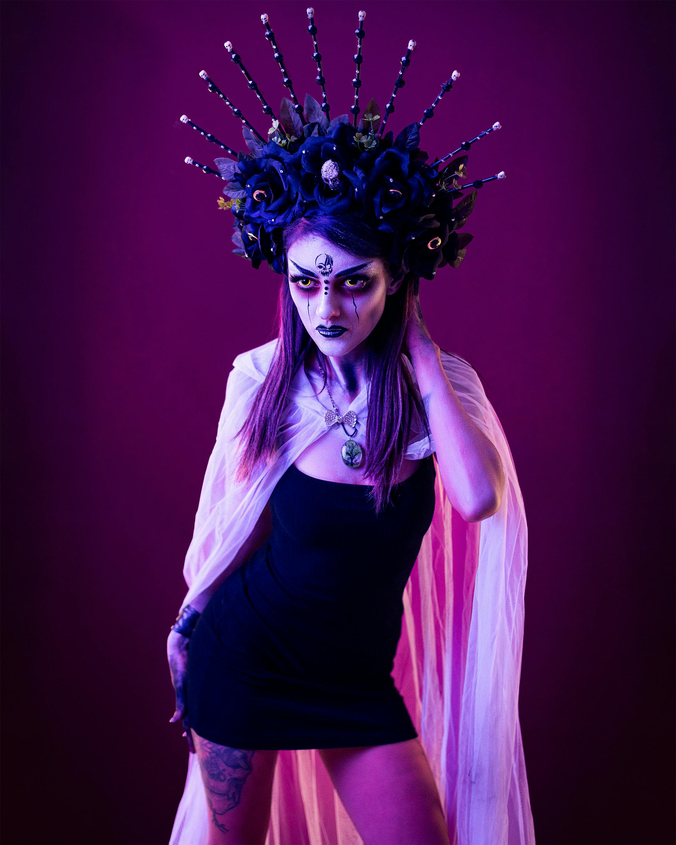 [ColoSach]-a-striking-portrait-of-a-woman-in-floral-headdress-with-vivid-makeup-on-purple-backdrop.