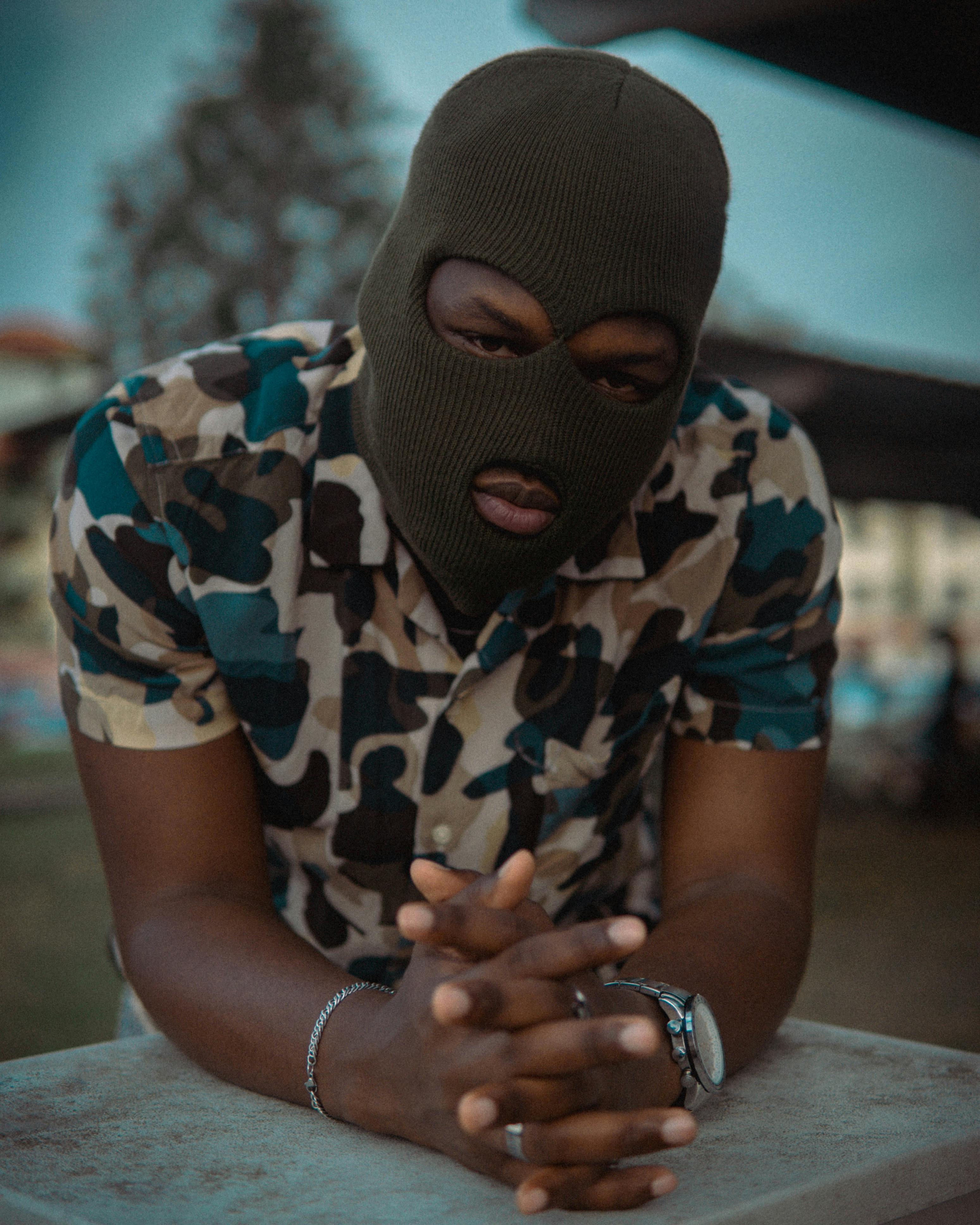 Prescription Goggle Inserts - A person in camouflage with a ski mask outdoors, capturing a candid moment.