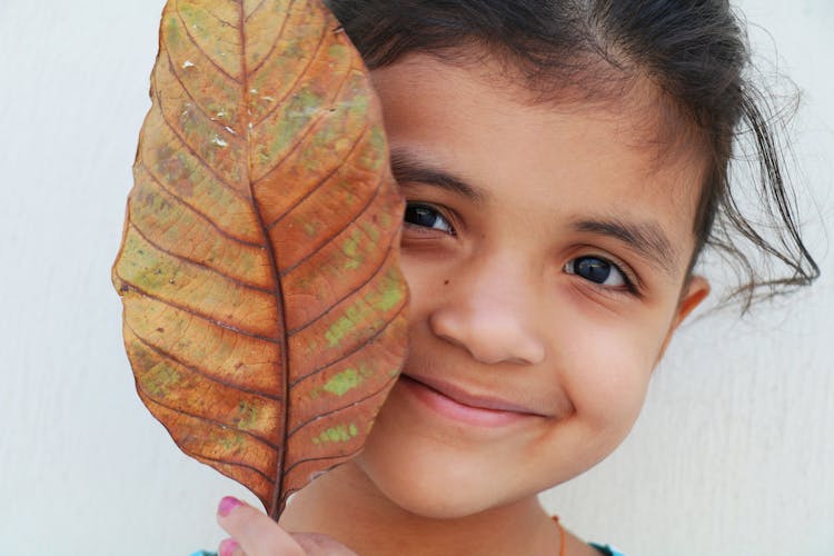 Young Girl Holding A Leaf