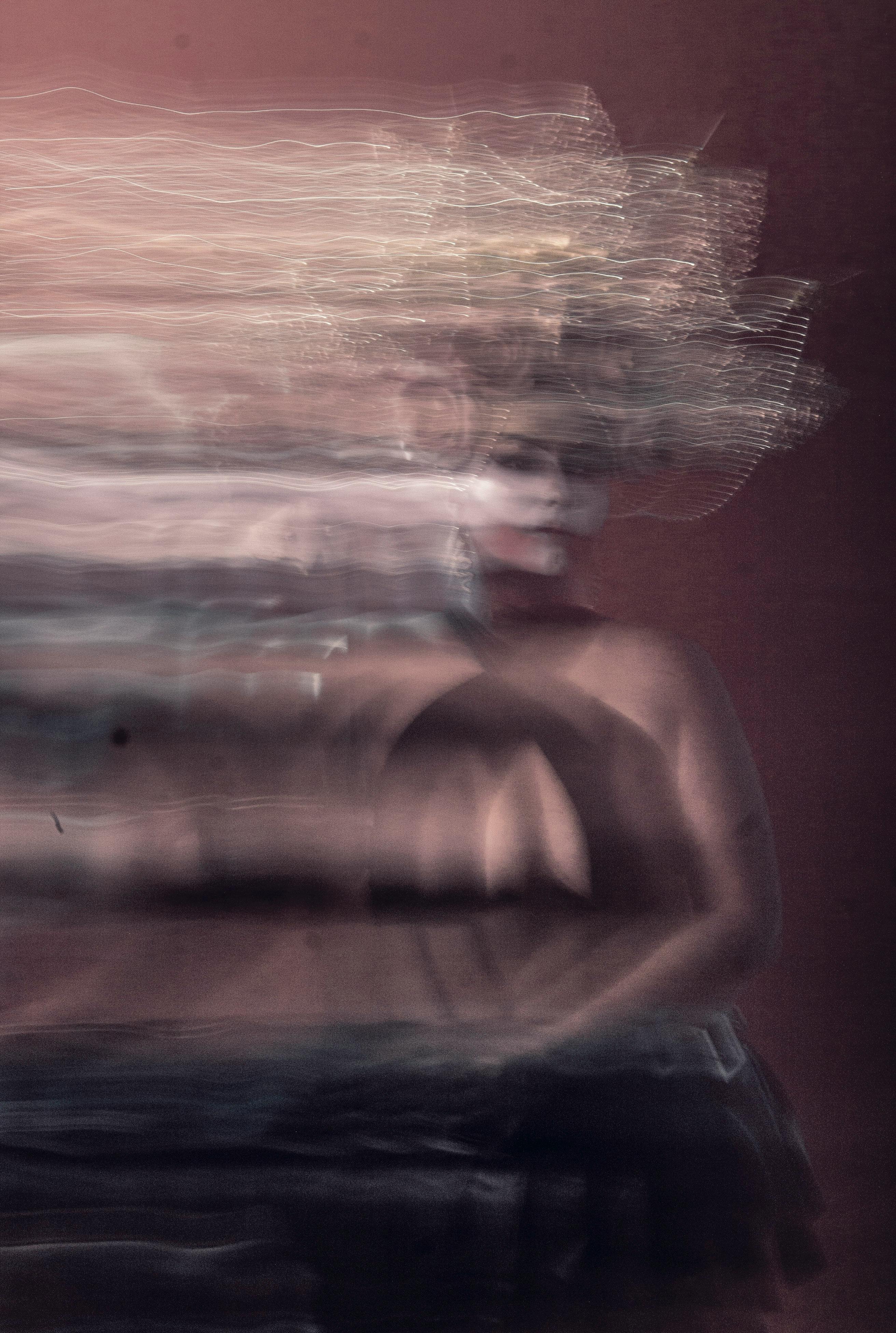 Surreal blurred portrait of a woman with dynamic motion effect.