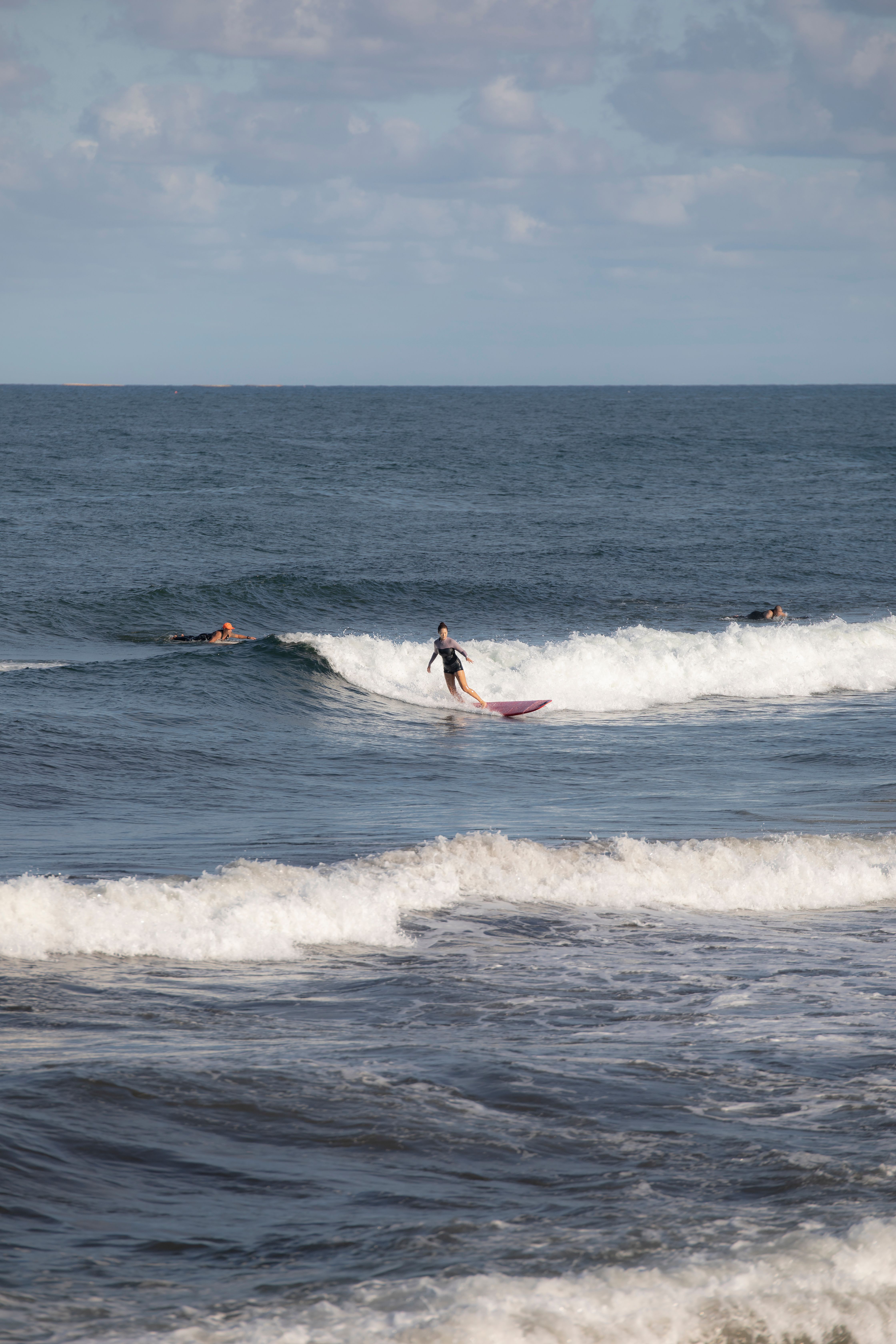 Surfers Riding Waves on an Ocean Summer Day · Free Stock Photo