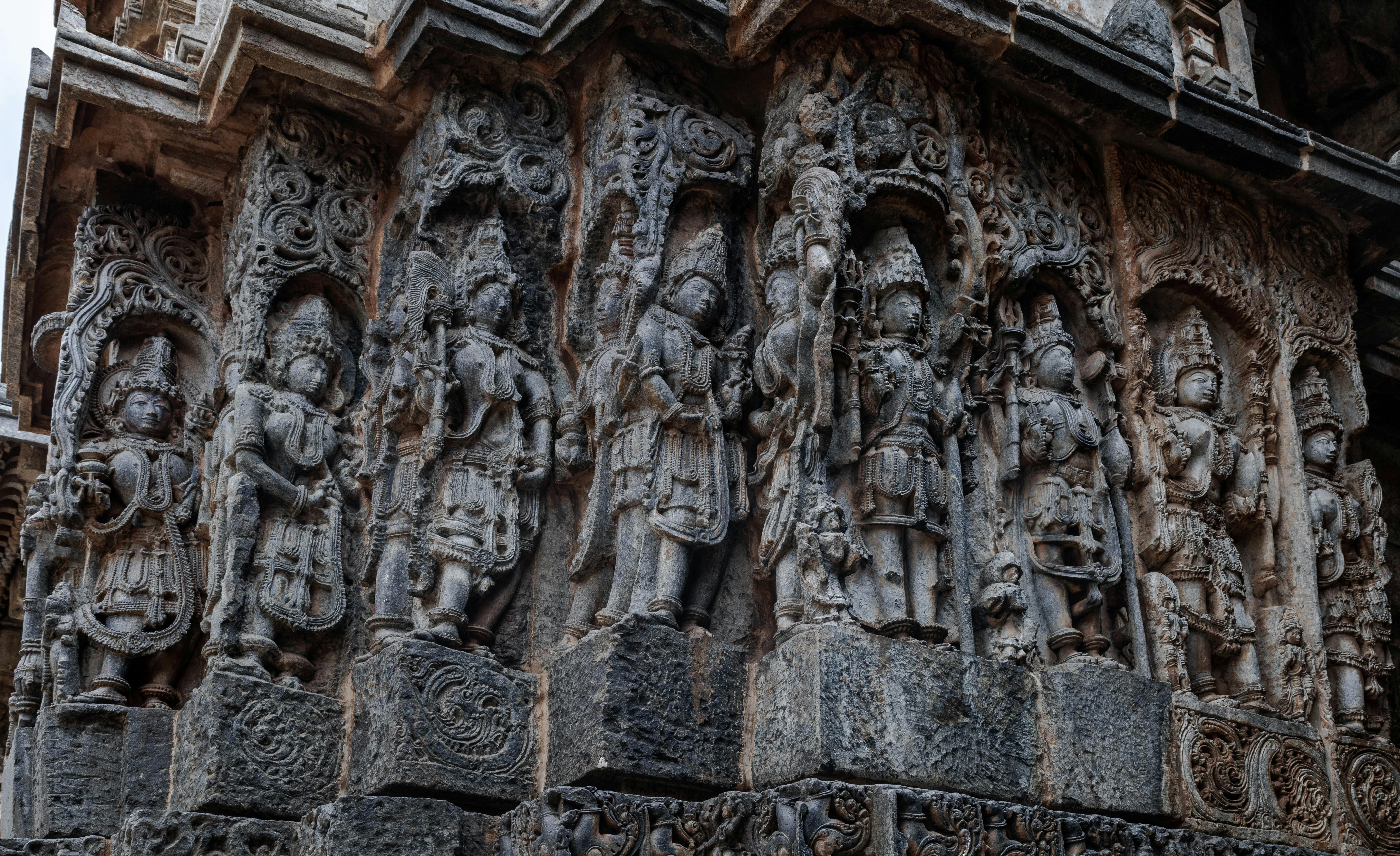 Close-up of intricate stone carvings at Halebidu Temple showcasing ancient Indian artistry and architecture.