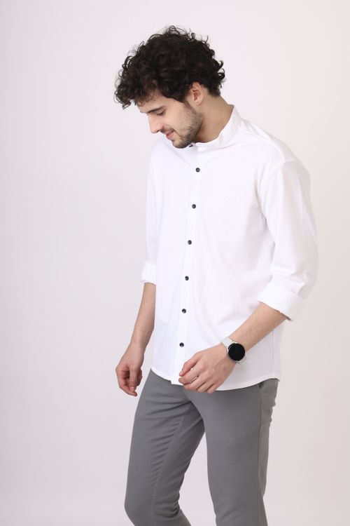 Free Man wearing white shirt and gray pants, looking down, isolated on white background. Stock Photo