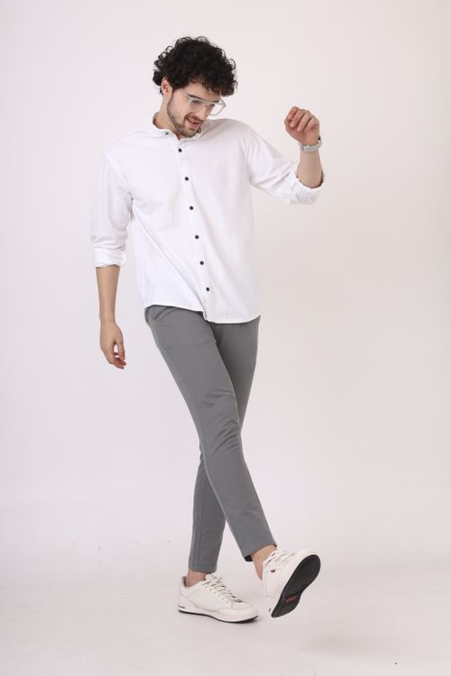 Free Young man in casual outfit striking a joyful pose, full-length photo. Stock Photo