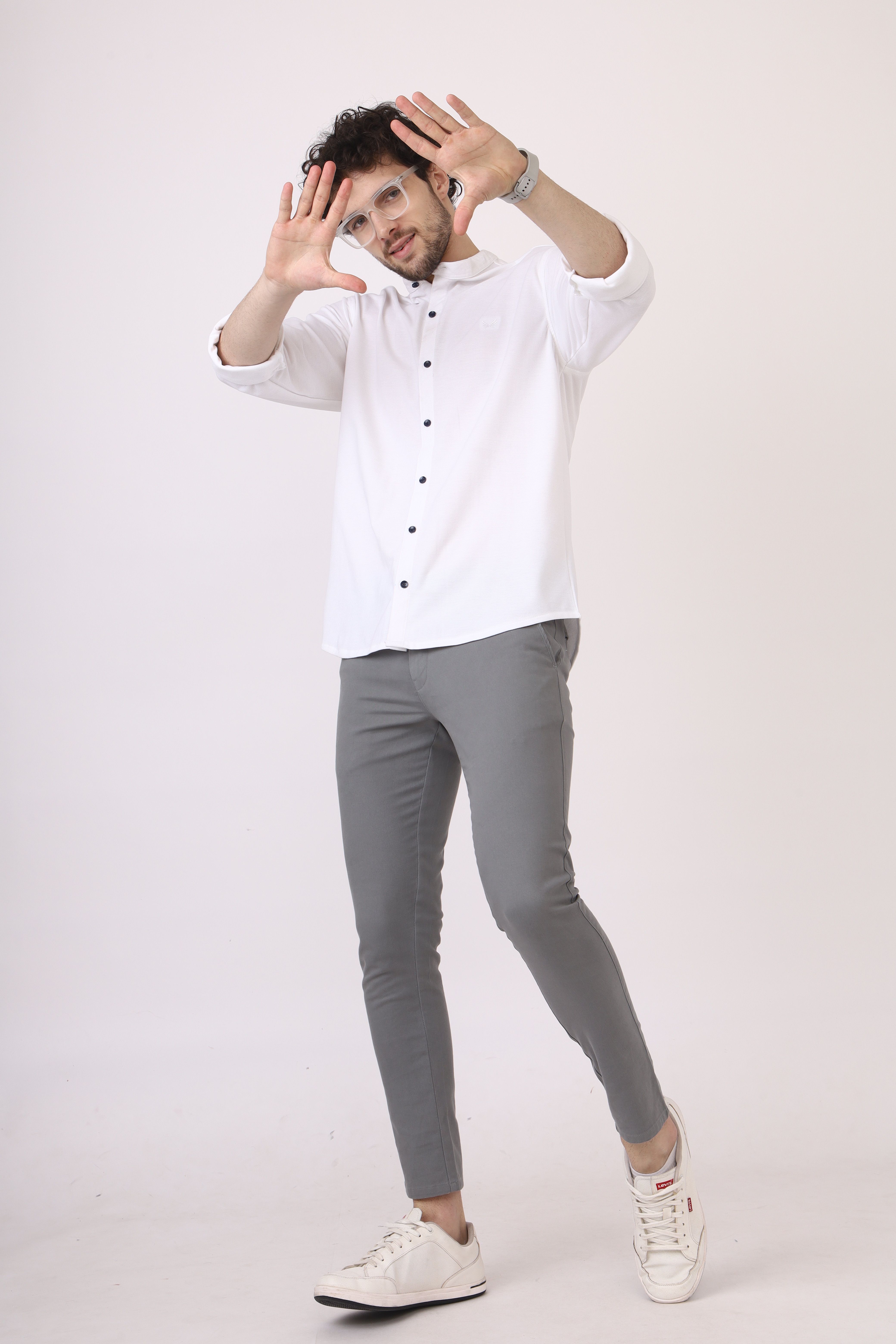 Casual Man Posing in White Shirt and Grey Pants  Free Stock Photo