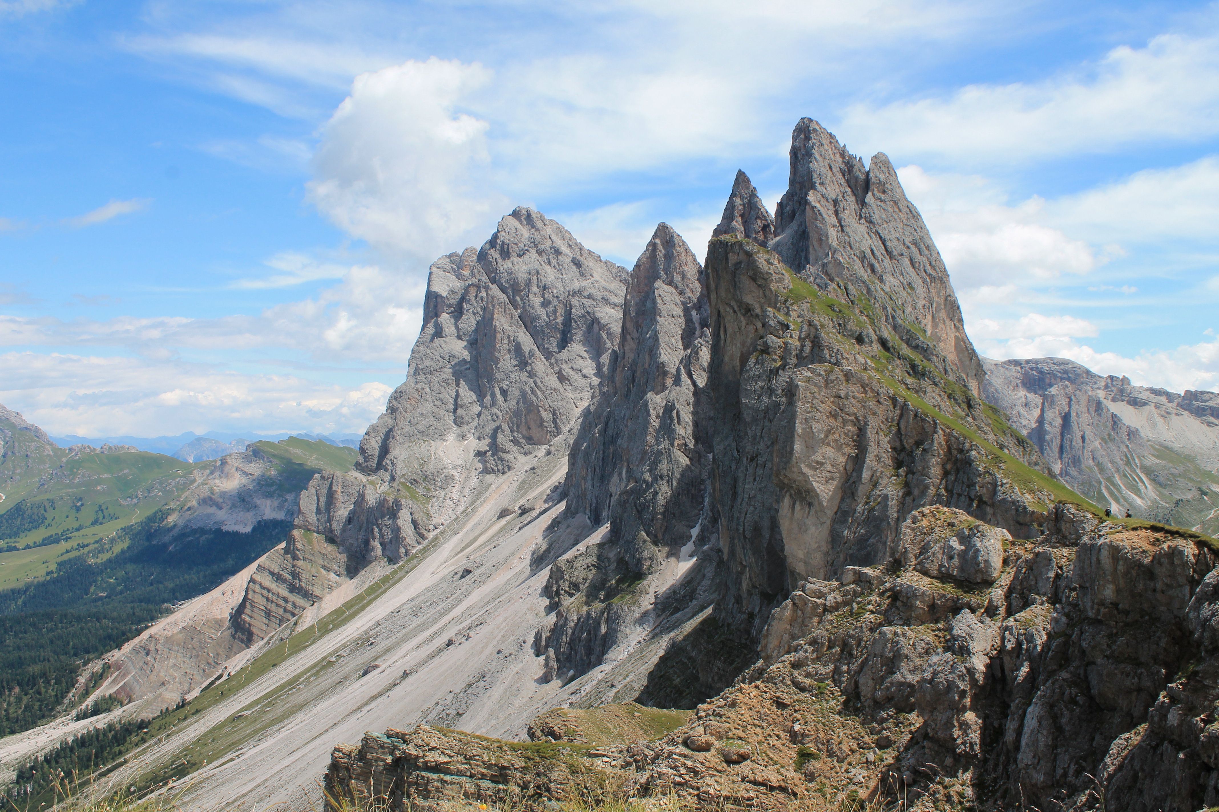 Breathtaking view of the jagged Seceda peaks in the Dolomites, Italy, under a bright blue sky. Breathtaking view of the jagged Seceda peaks in the Dolomites, Italy, under a bright blue sky.