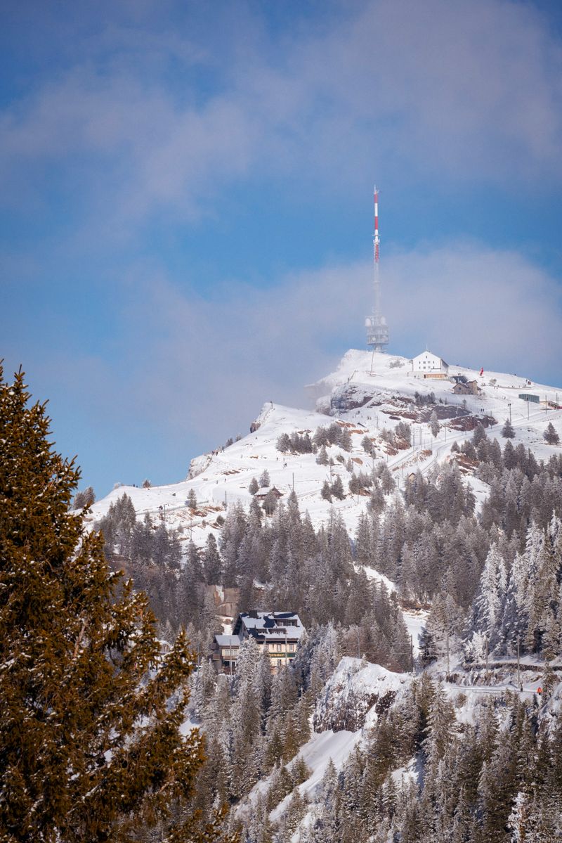Snowy mountain with communication tower in extreme winter climate