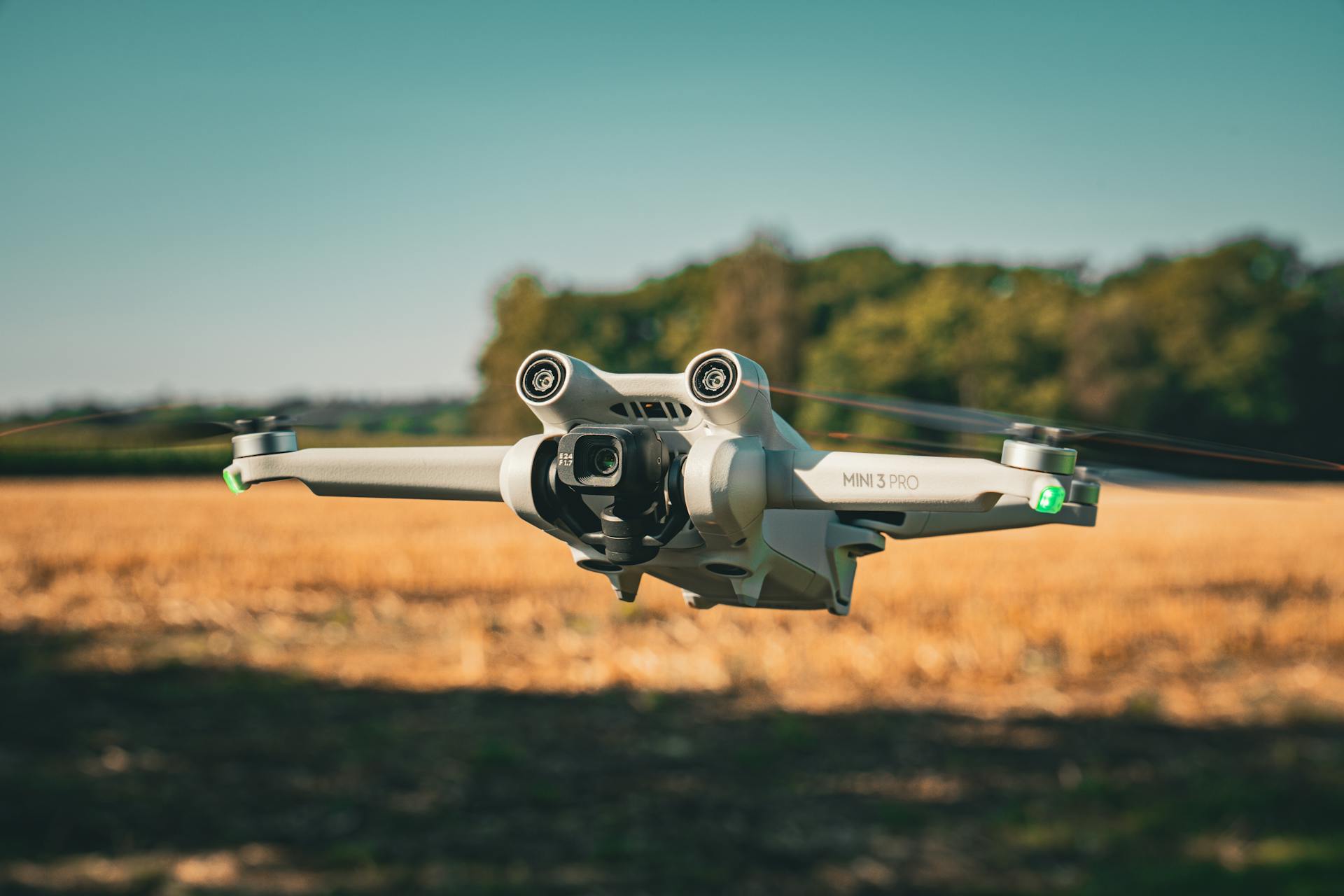 Flying Drone in a Field Under Clear Sky