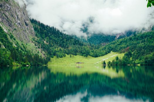 A tranquil mountain lake with stunning reflections in the Bavarian Alps, Germany.