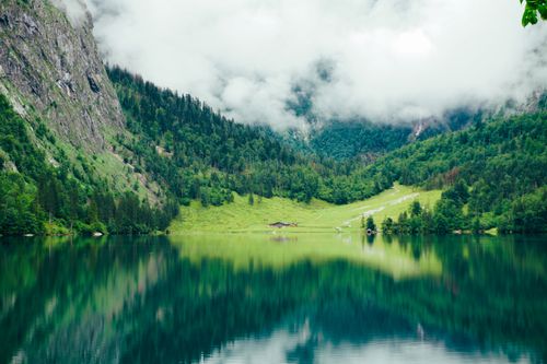 Free A tranquil mountain lake with stunning reflections in the Bavarian Alps, Germany. Stock Photo