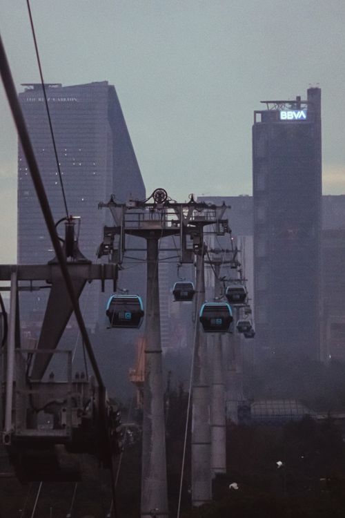 Free Dramatic cityscape featuring cable cars and skyscrapers against a dusky sky. Stock Photo